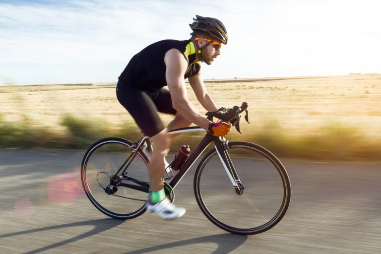 handsome young man cycling on the road.