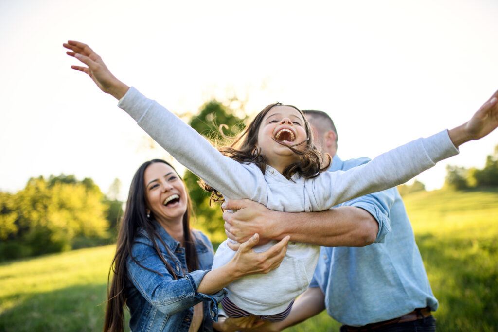 Happy family with small daughter - Chiropractic care for kids